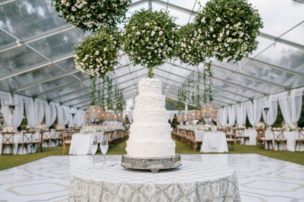 floral applique wedding cake in luxury wedding tent