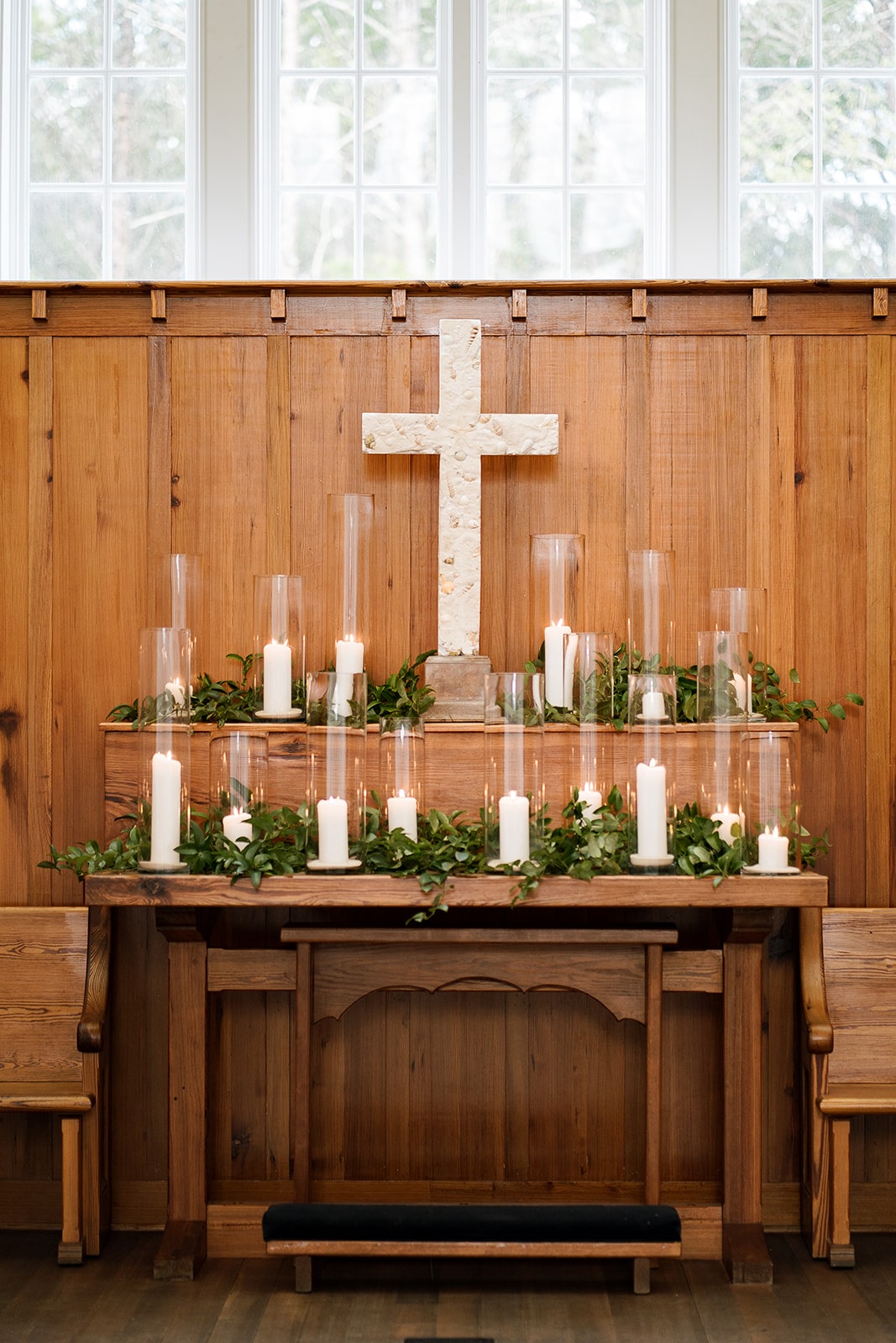 Church decor with candles and greenery