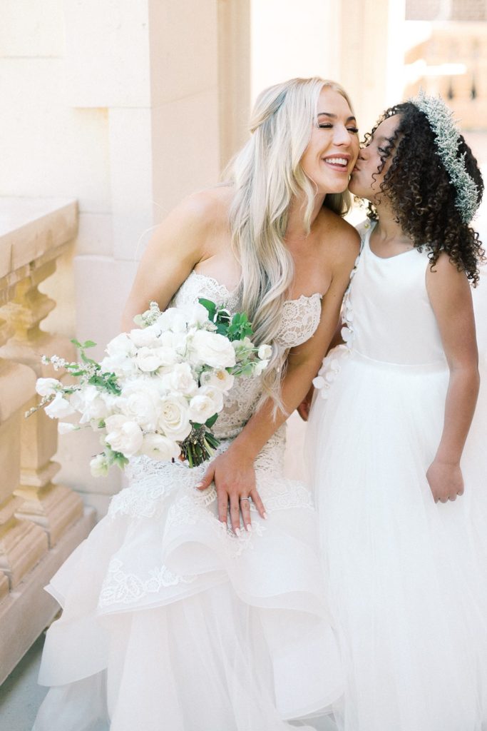 Bride with flower girl in white dress