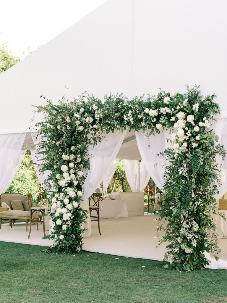 Floral and green tent entrance at WaterColor tented wedding