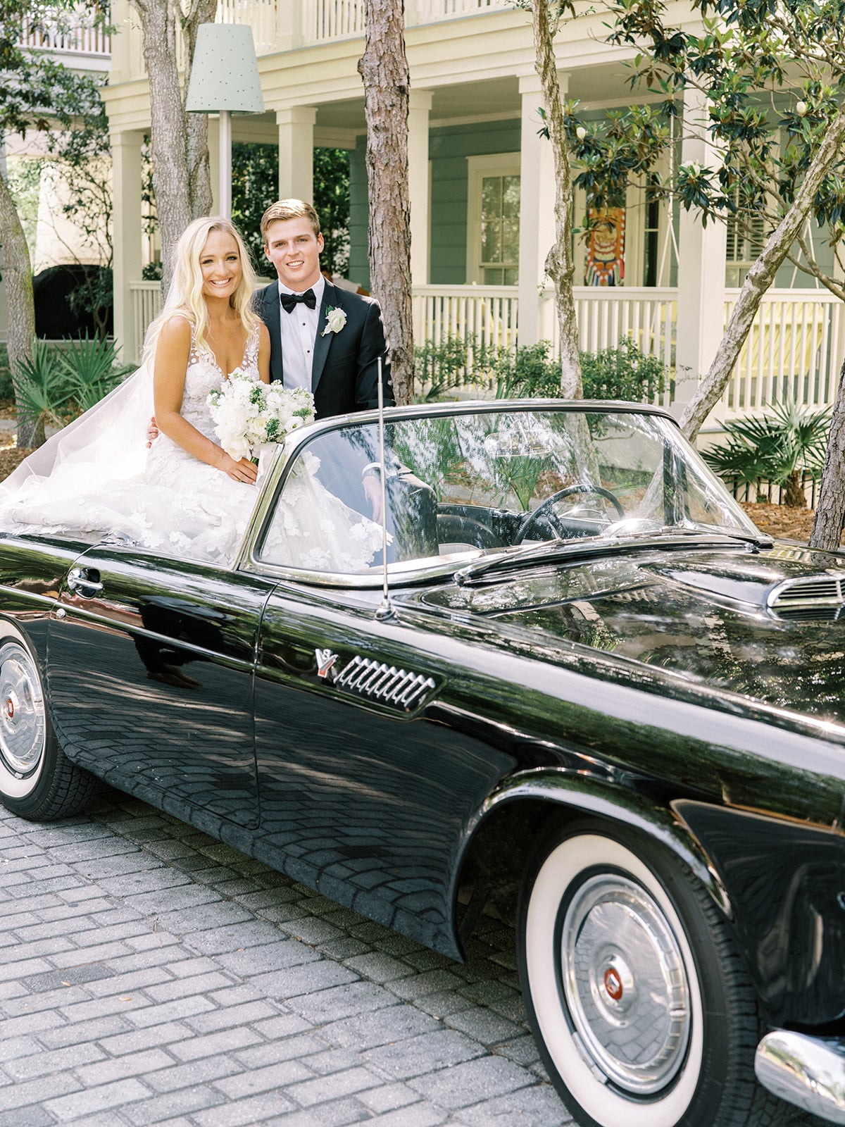 Bride and groom portraits on vintage car