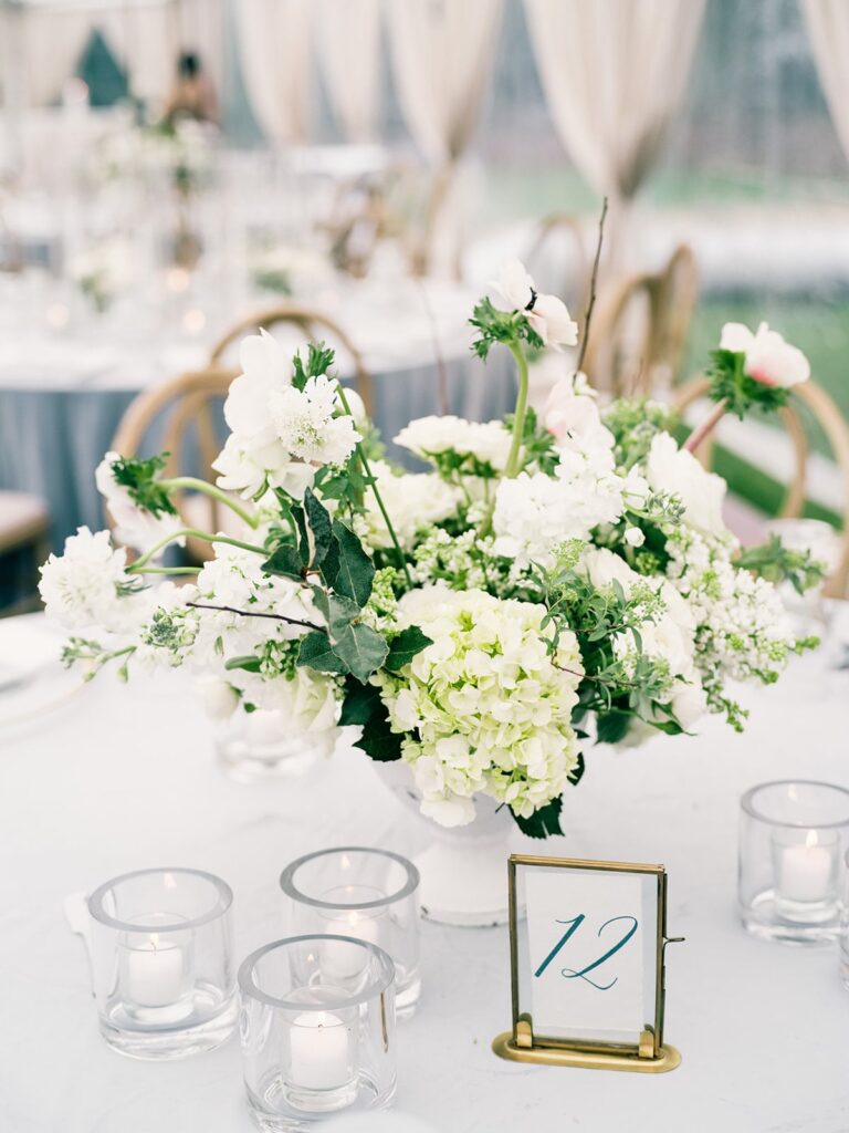 White floral centrepiece on white wedding table