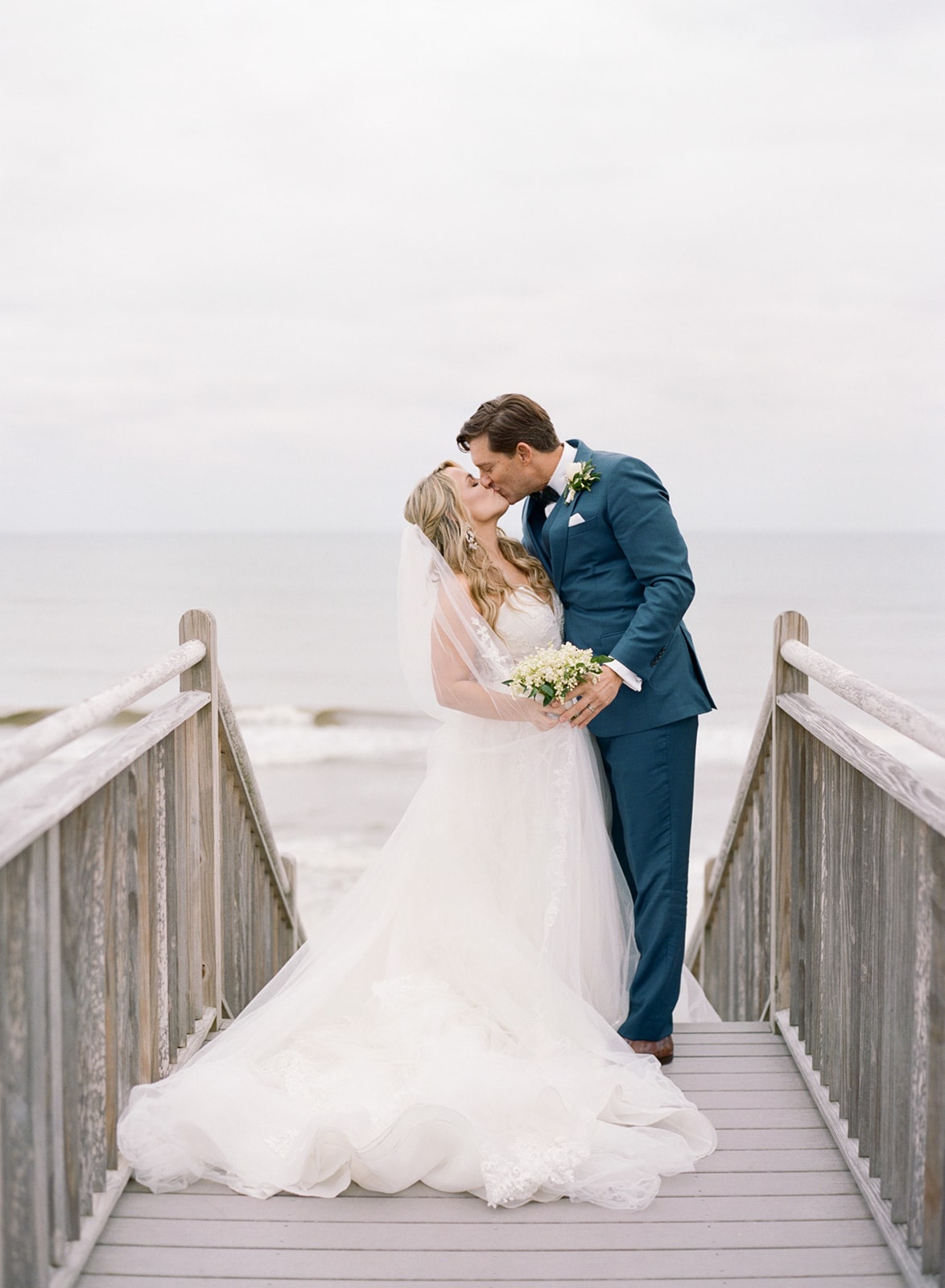 Bride and groom kissing at Carillon beach