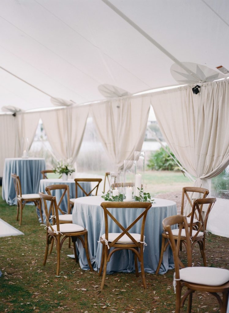 wedding tables with blue linens and wood chairs