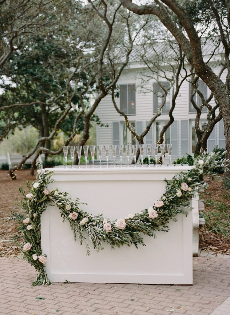 white bar with greenery boughs