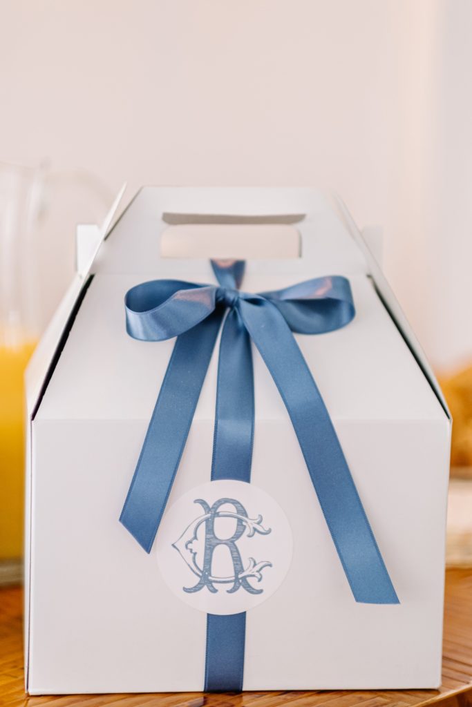 white box with blue ribbon
