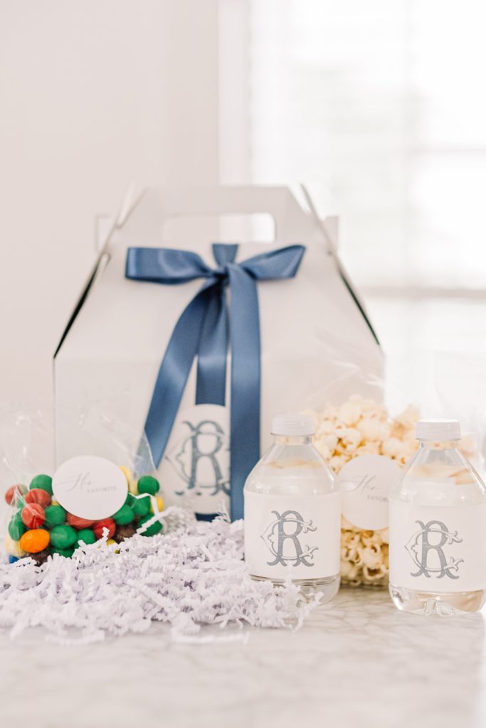 white box with blue ribbon with popcorn and candy