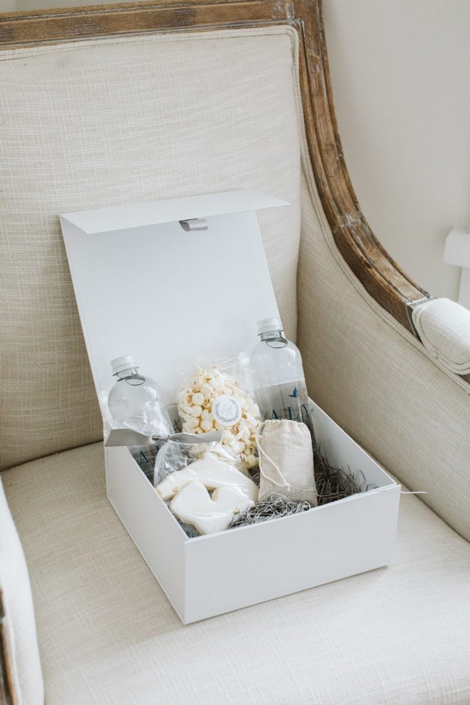 White wedding welcome gift box with water and popcorn