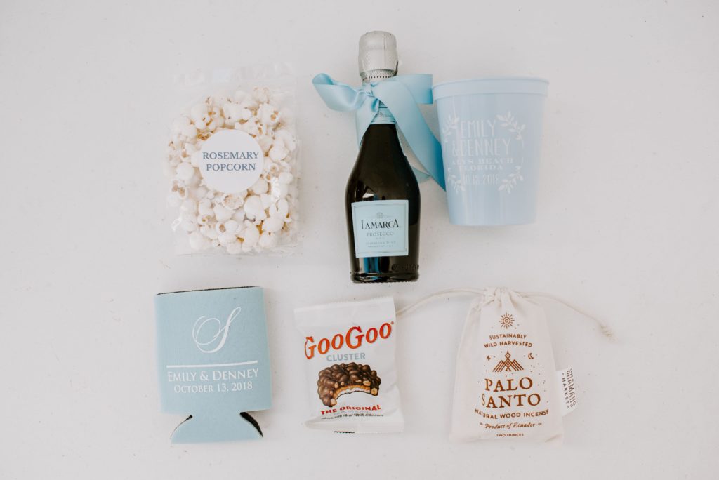 champagne and custom blue cup with popcorn and custom beer koozie 
