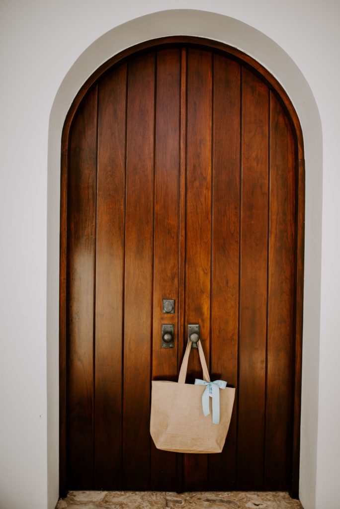 cloth bag with blue ribbon hanging on door