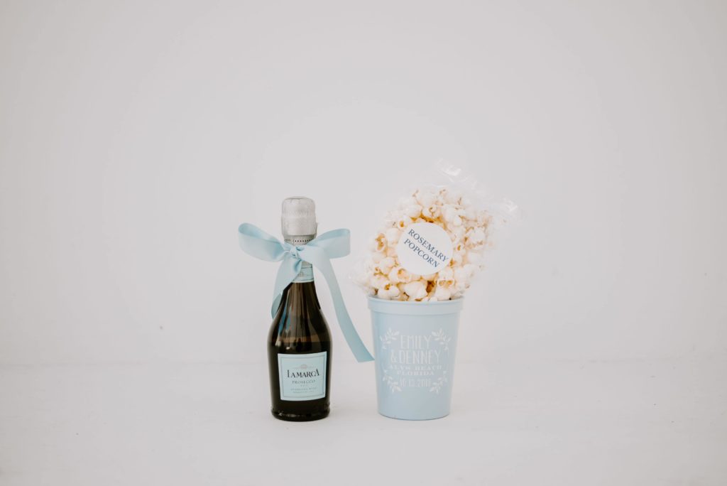 champagne and custom blue cup with popcorn
