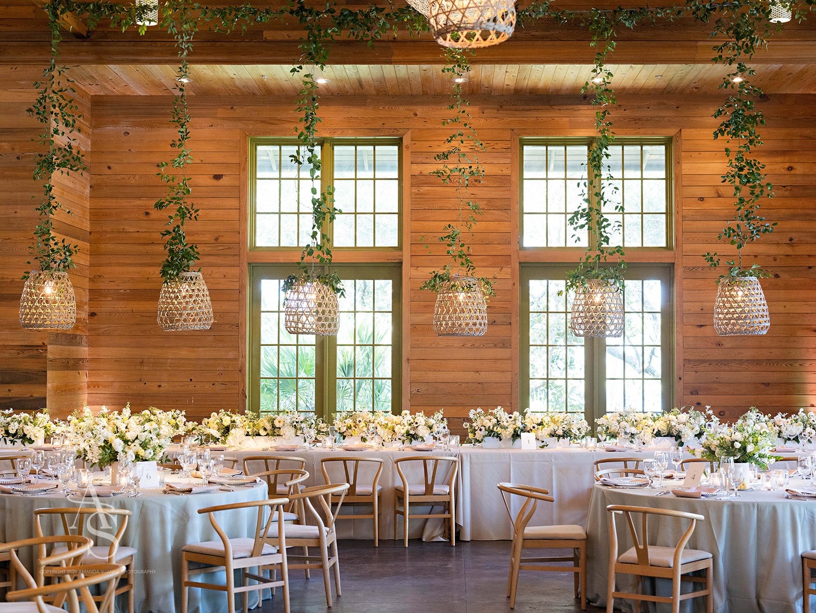 Wedding reception with white tables and wood chairs